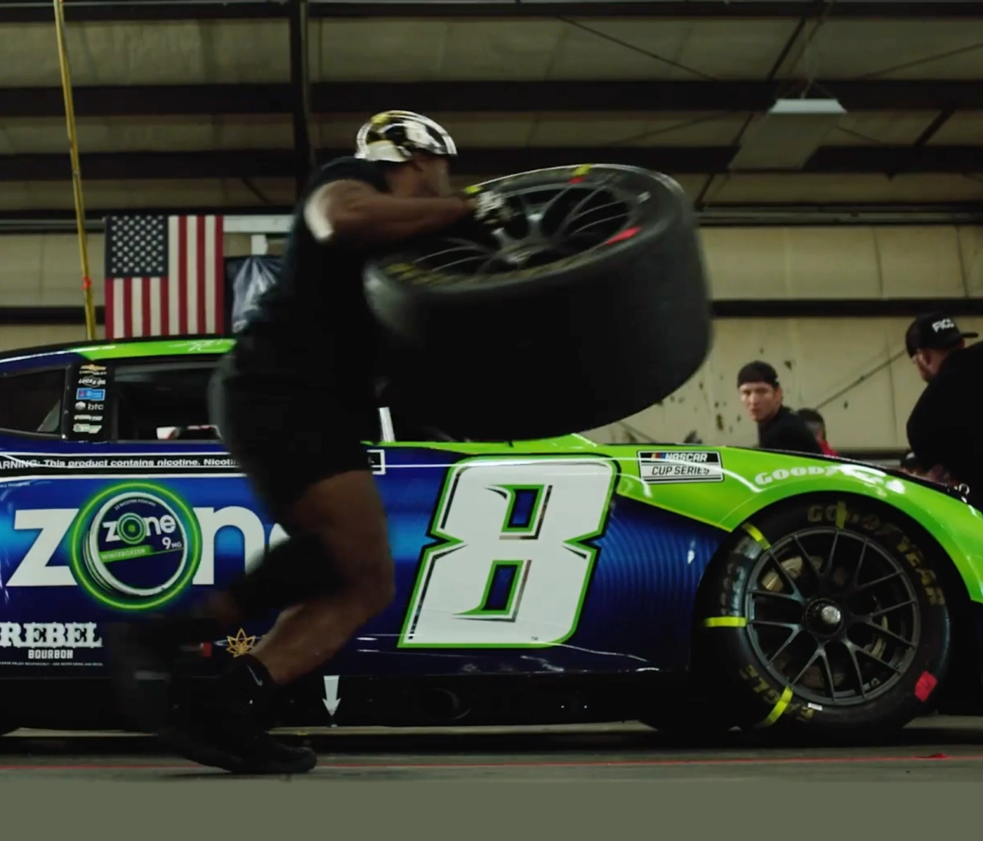 Pit Crew changing a tire on the Zone car