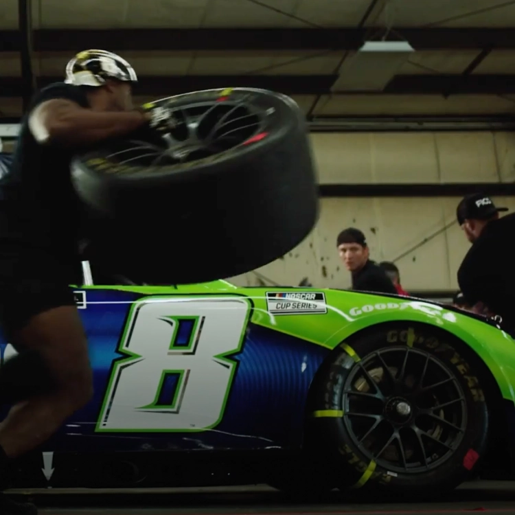 Pit Crew changing a tire on the Zone car